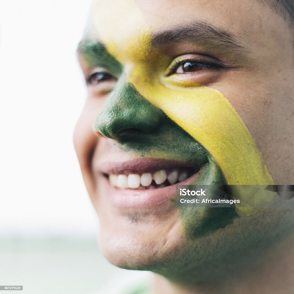 Brazilian Football Fan A Brazilian football fan with face paint. Adult Stock Photo