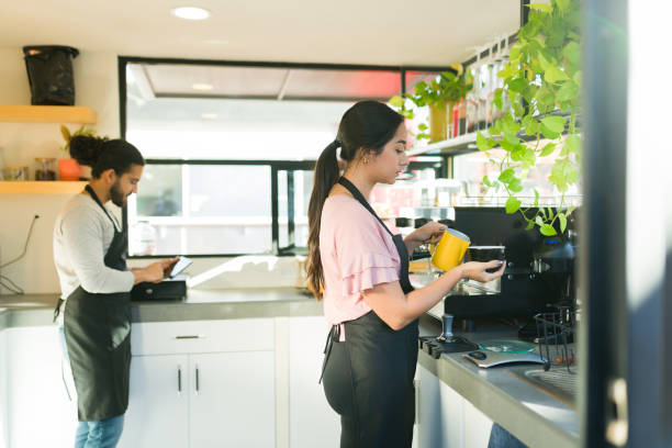 istock Hispanic baristas making drinks working in the coffee shop 1872715512