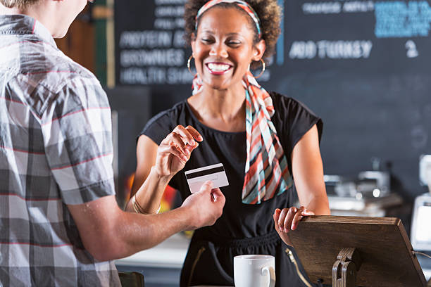 istock Woman cashier taking payment from customer 187272452