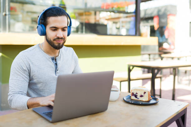 istock Handsome man in the coffee shop working with his laptop 1872729255