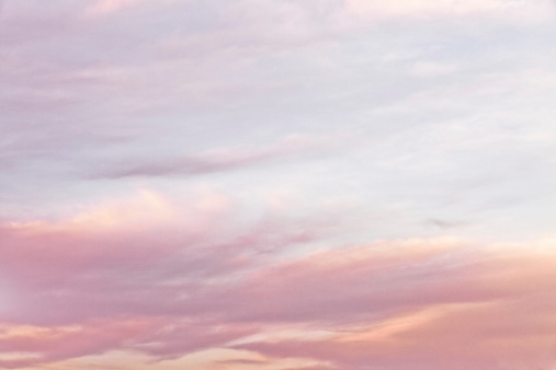 Soft and dreamy pastel sky with clouds.