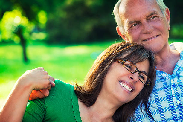 istock Senior couple hugging in park 187274763