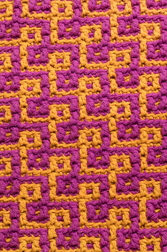 Purple yellow crochet mosaic texture with abstract geometric pattern.