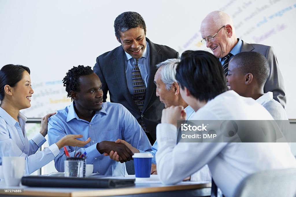 Successful businesspeople shaking hands making a necessary agreement Successful businesspeople shaking hands making a necessary agreement during a meeting Japanese Ethnicity Stock Photo