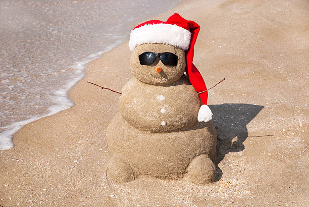 istock Sandy snowman in santa hat. Christmas holiday concept 187276228
