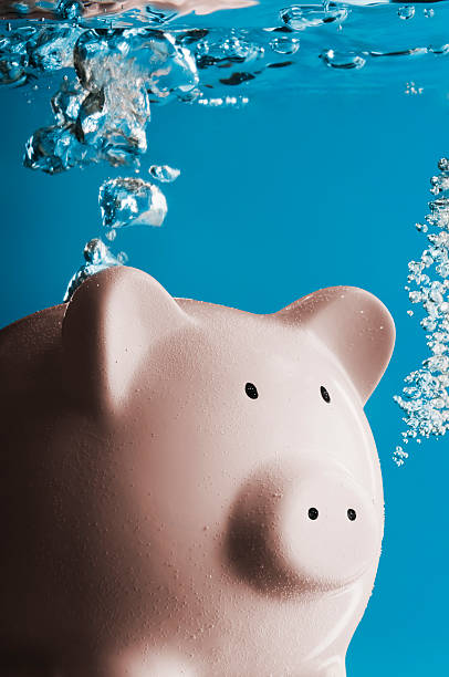 istock Piggy bank under water with bubbles rising up 187276305