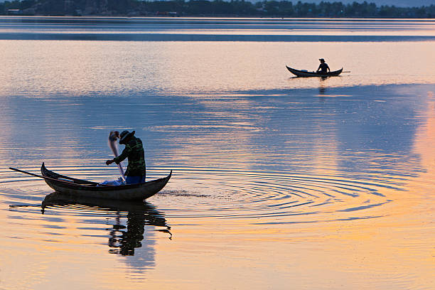 istock Men on a small wooden boat in Phan Rang sea 187276399