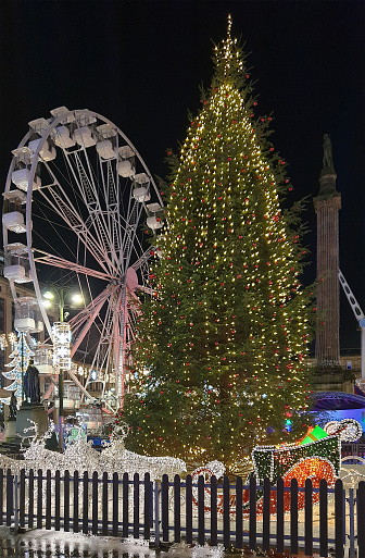 Glasgow, Scotland - 18th December 2023: George Square decorated for its annual Winterfest, with a Christmas tree, a Big Wheel and an illuminated sleigh drawn by reindeer.