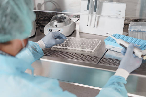 istock Back view of scientist is using micropipette for biochemical test analysis in medical laboratory 1872779965