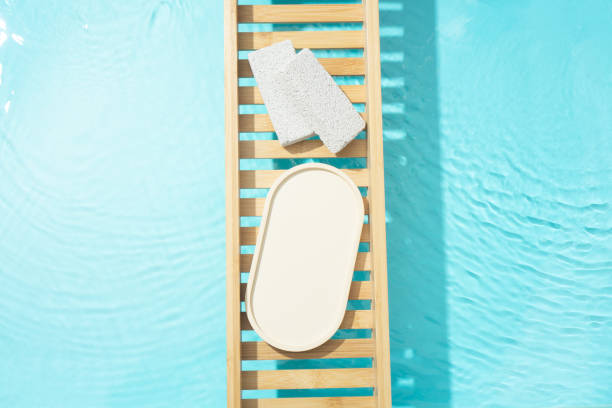 istock Cosmetic product presentation flat lay scene made with empty tray on bath tray above the transparent blue water. Template for self-care product placement. 1872780488