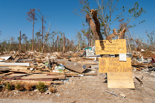House debris in Diamondhead, Mississippi, after 2005 Hurricane Katrina where the entire town suffered catastrophic damage by 115mph winds and 28-foot storm surge. Some returning residents found humor in the  natural disaster.