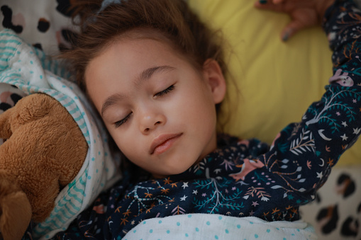 Shot of an adorable little girl sleeping peacefully in bed at homeShot of an adorable little girl sleeping peacefully in bed at home