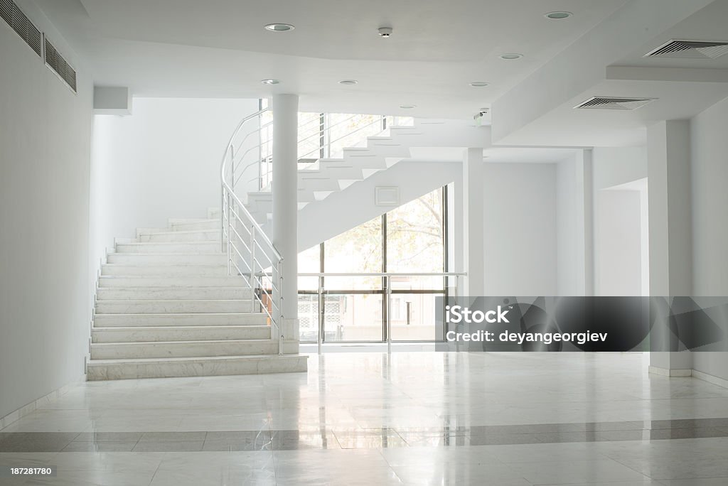 Interior of a building with white walls Interior of a building with white color walls. Flight of stairs Lobby Stock Photo