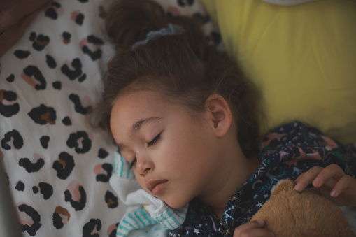 Shot of an adorable little girl sleeping peacefully in bed at homeShot of an adorable little girl sleeping peacefully in bed at home