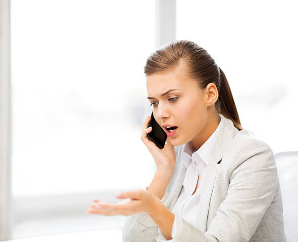 istock woman shouting into smartphone 187282150