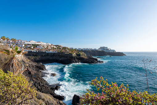 A coastal view of Los Gigantes, Tenerife with the Atlantic Ocean in the foreground.