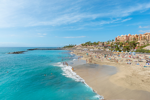 Sandy beach with thatched parasols and sunbeds, Costa Adeje, Tenerife
