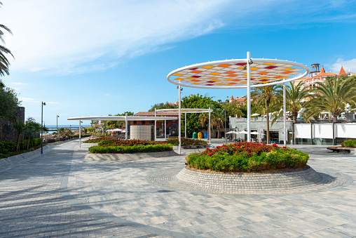 Del Duque, Costa Adeje, Tenerife, Canary Islands, Spain. Small square in front of the popular beach Playa del Duque, with access to a resting areas, to the shopping center and hotels.