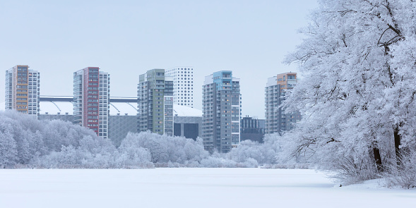 Winter view of the Råsta lake and modern apartment buildings in Arenastaden around the national stadium in Solna, Sweden.