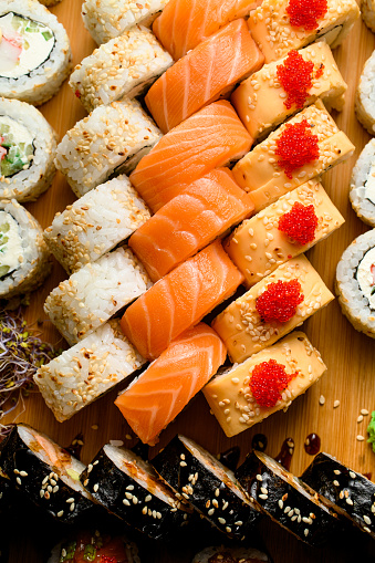 Set of various rolls with tuna, salmon, eel, avocado, cucumber, tobiko calve. Big sushi set. Japanese food.
