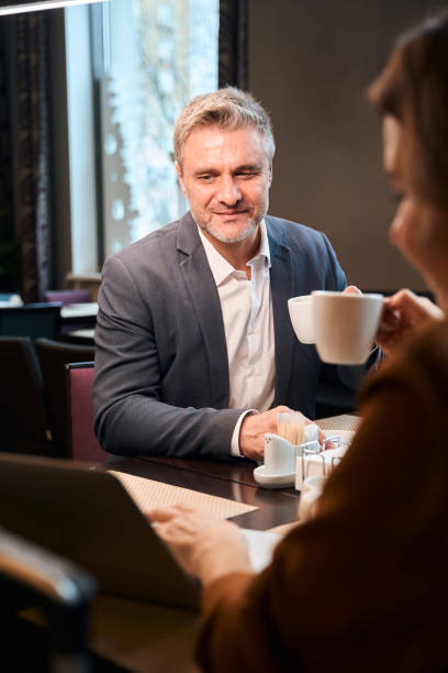 istock Couple watching something on laptop during coffee time 1872876457