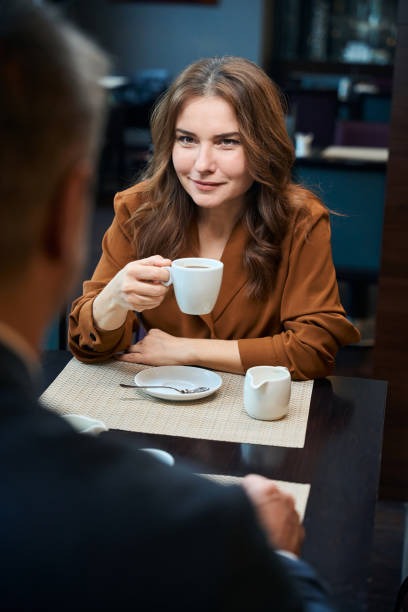 istock Smiling woman sitting at the table in a restaurant 1872876488