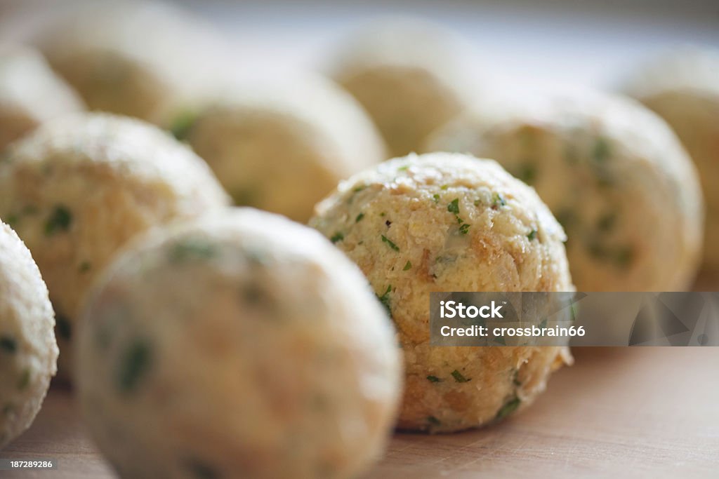 South tyrolean dumplings in a row on breadboard Dumpling Stock Photo