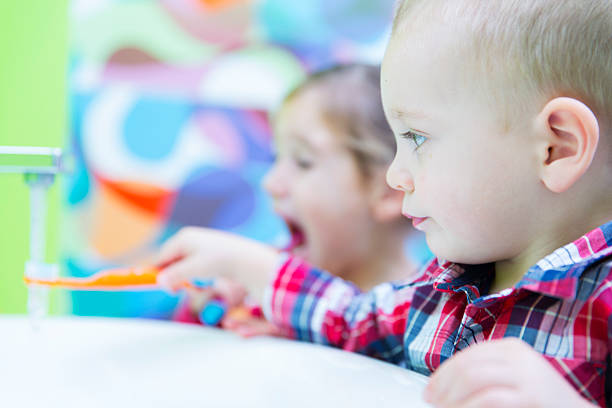 istock Little boy and his sister brushing teeth 187289776