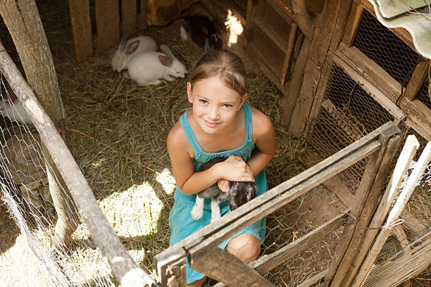 istock cute girl in rabbit farm 187289994
