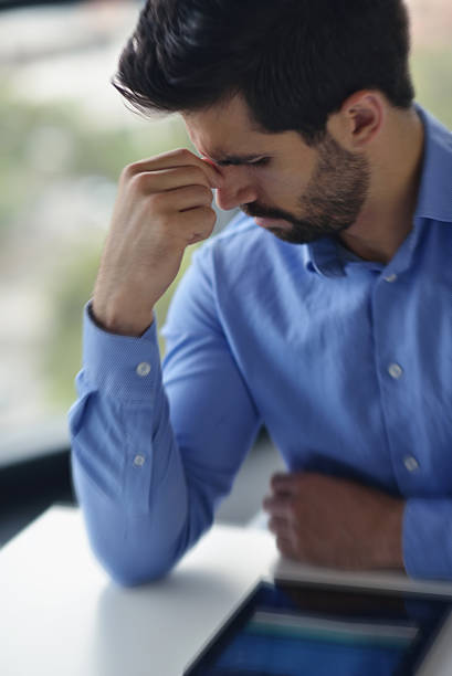 istock business man with problems and stress in the office 187290099