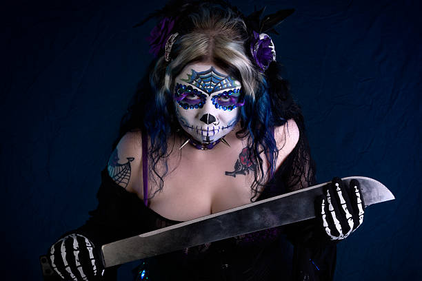 istock Woman in sugarskull makeup leaning forward menacingly. 187290297