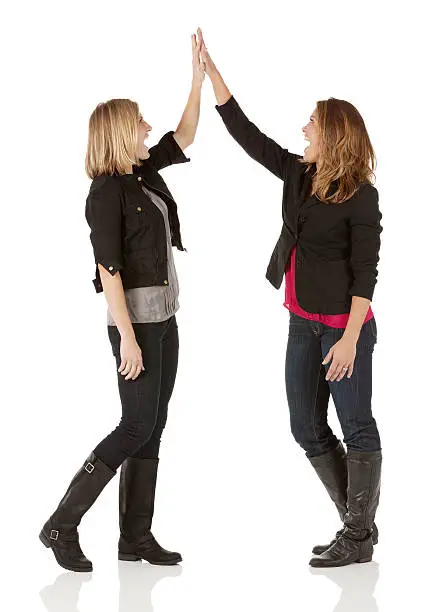 Youngwomen giving high-five to each otherhttp://www.twodozendesign.info/i/1.png
