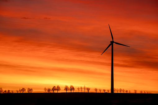 Wind turbine in barren landscape in morning light