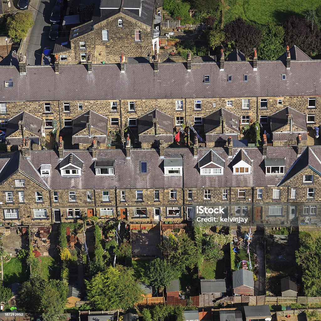 Stone terraced houses from the air Aerial shot of stone terraced houses on the outskirts of Leeds.  Row House Stock Photo