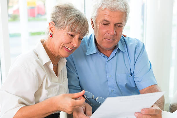 istock Senior couple read the form for life insurance 187292975