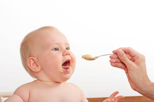istock spoonfeading  baby food 187293386