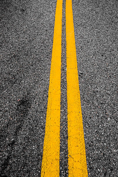 istock Closeup of double yellow lines 187293453