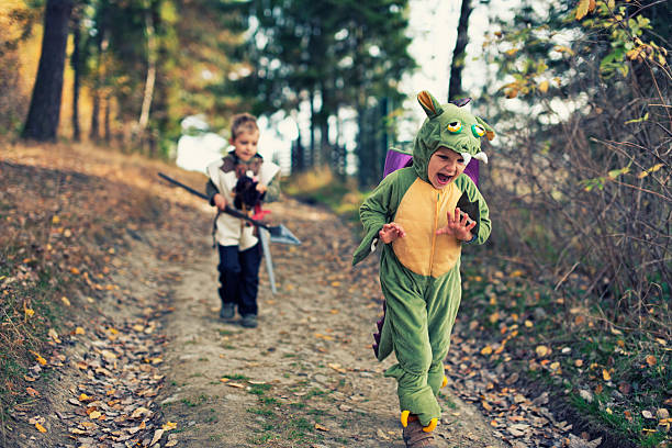Dragon chased by a fearsome knight Scared green dragon running away from a charging knight. costume stock pictures, royalty-free photos & images
