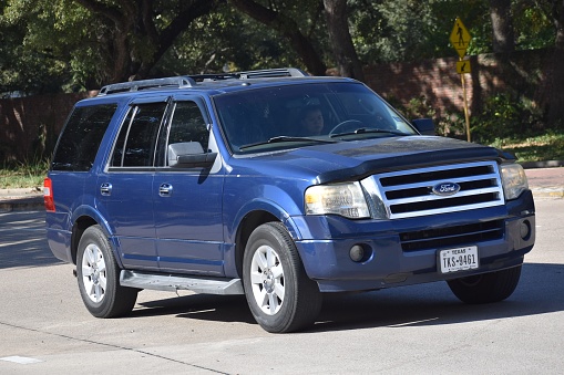 Houston, TX USA 12-19-2023 - A vintage and blue Ford Expedition SUV cruising near Herman Park in Houston