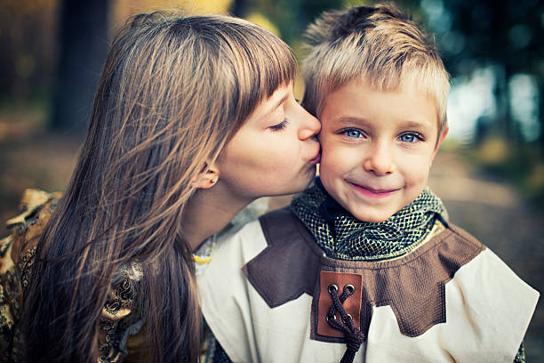 Little princess kissing the little knight that saved her from the dragon.
