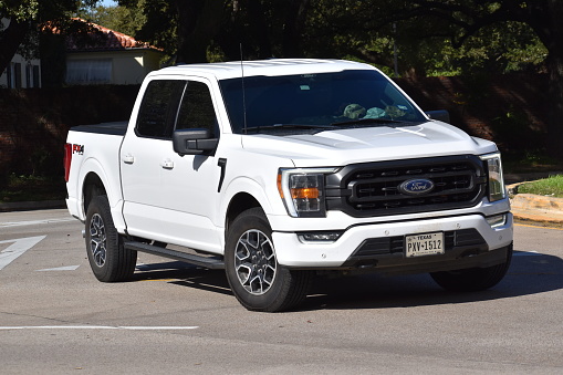 Houston, TX USA 12-19-2023 - A white Ford pick-up truck cruising near Herman Park in Houston