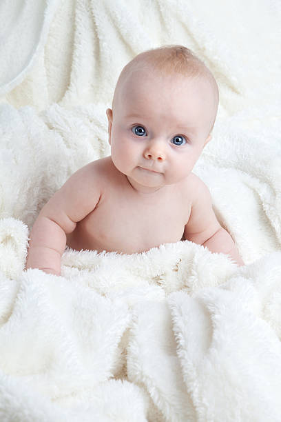 istock Baby Girl Sitting in White Blanket 187296050