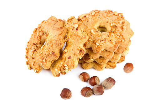 Nut cookies and hazelnut fruits isolated on white background.