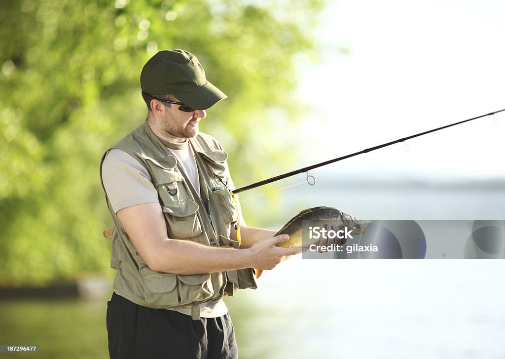 Fisherman. Fisherman on a river/lake showing his catch. 30-39 Years Stock Photo