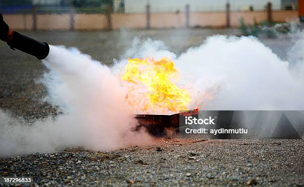 A Fireman Extinguishing A Fire Stock Photo - Download Image Now - Fire Extinguisher, Talcum Powder, Fire - Natural Phenomenon