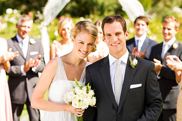 istock Newlywed Couple With Guests Clapping In Background 187296995