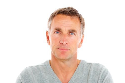 Portrait of handsome mature man looking at camera against white background