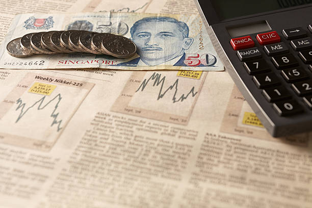 Newspaper stock market with calculator and money stock photo