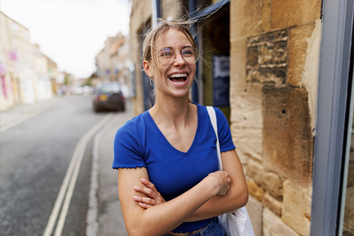 Portrait of a teenage girl enjoying summer vacations in Gloucestershire, United Kingdom. \nThe girl is wearing a modern, translucent dental aligner and she is laughing happily.\nShot with Canon R5