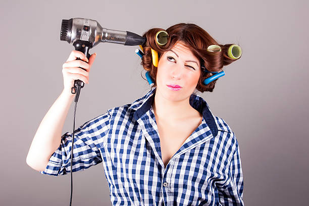 istock girl with hair blower 187300133